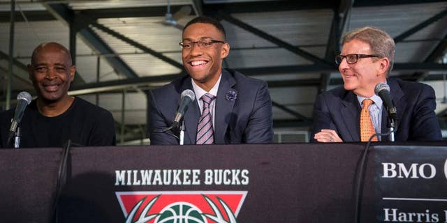 Milwaukee Bucks first round draft pick Jabari Parker is flanked by coach Larry Drew, left, and general manager John Hammond as he is introduced at a news conference Friday, June 27, 2014, in Milwaukee. (AP Photo/Morry Gash)