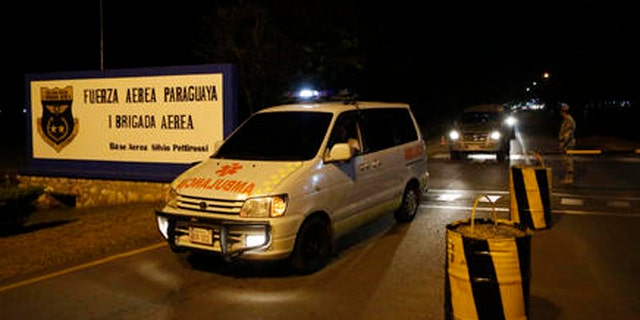 Ambulances transport the coffin of one of Paraguay's army soldiers killed in an attack on Saturday, Aug. 27, 2016, in Arroyito at asuncion airport, Paraguay. Suspected members of a little-known Paraguayan guerrilla group killed multiple soldiers in the attack in Arroyito. (AP Photo/Jorge Saenz)