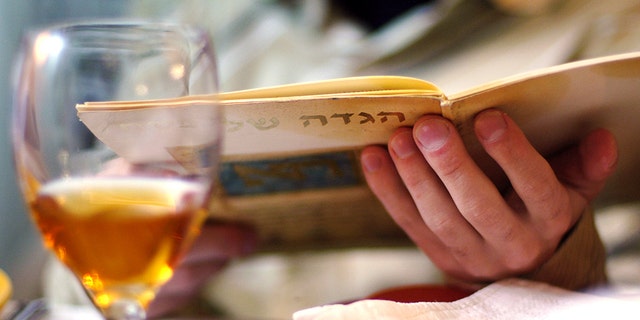 A man is shown reading the Haggadah book during Passover Seder dinner. The Jewish people's continuous observance of national holy days and rituals, said author and conservative radio talk show host Dennis Prager, is one of the chief reasons the Jews have survived for 3,500 years.