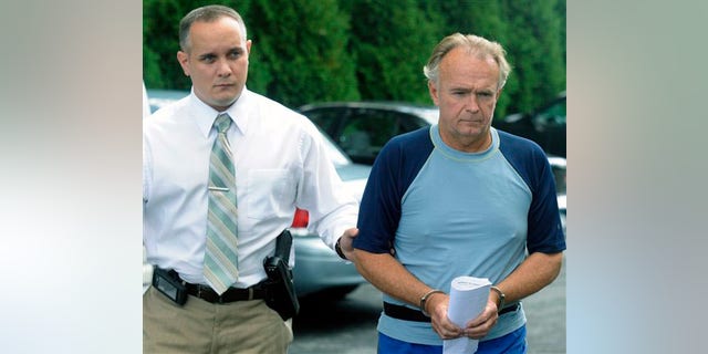 The Rev. Arthur Burton Schirmer, 62, right, is led into district court by Pennsylvania State Trooper Bill Skotleski in Tannersville, Pa., on Monday, Sept. 13, 2010. Schirmer is accused of killing his wife and staging a car accident in July 2008 to cover up the murder.