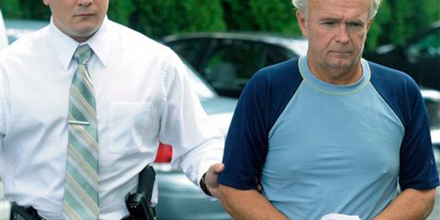 The Rev. Arthur Burton Schirmer, 62, right, is led into district court by Pennsylvania State Trooper Bill Skotleski in Tannersville, Pa., on Monday, Sept. 13, 2010. Schirmer is accused of killing his wife and staging a car accident in July 2008 to cover up the murder.