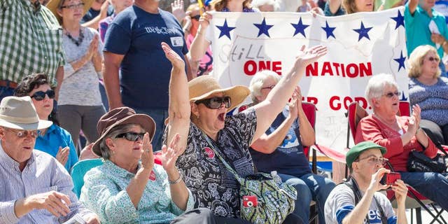 Members of the crowd cheer during a Christian conservatives rally outside the Tennessee Capitol on Thursday, Sept. 17, 2015, in Nashville. The event featured Joe Davis, the husband of Kentucky clerk Kim Davis, and Rafael Cruz, the father of U.S. Sen. Ted Cruz, a Republican presidential candidate. (AP Photo/Erik Schelzig)