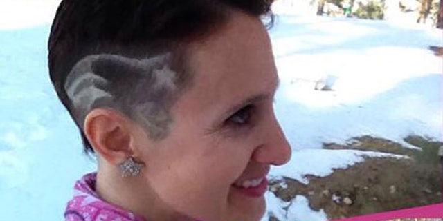 Paula McDonald, who is fighting breast cancer, said she hopes her move to have the Patriots logo shaved on the side of her head helps her team and raises awareness to perform self-examinations.