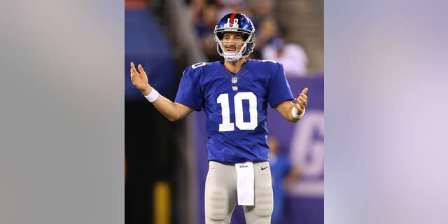 New York Giants quarterback Eli Manning reacts during the first half of an NFL preseason football game against the New England Patriots, Thursday, Aug. 28, 2014, in East Rutherford, N.J. (AP Photo/John Minchillo)
