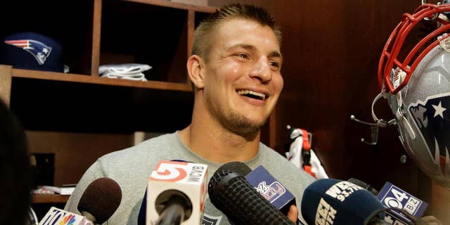FILE - This Sept. 4, 2013, file photo shows New England Patriots tight end Rob Gronkowski smiling as he talks to the media at the NFL football team's facility in Foxborough, Mass. Gronkowski stood in front of his Gillette Stadium locker Monday, Sept. 1, 2014, and announced he will be playing in the New Patriots' opener at Miami this Sunday. (AP Photo/Stephan Savoia, File)