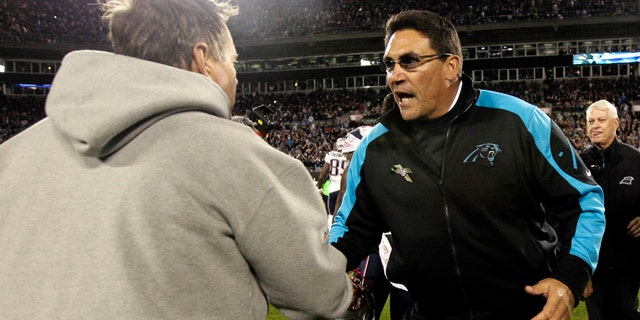 New England Patriots head coach Bill Belichick, left, and Carolina Panthers head coach Ron Rivera shake hands following an NFL football game in Charlotte, N.C., Monday, Nov. 18, 2013. Carolina won 24-20. (AP Photo/Gerry Broome)