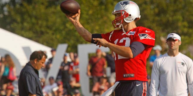 New England Patriots NFL teams quarterback Tom Brady (12) throws during a joint training camp with the Washington Redskins in Richmond, Va., Wednesday, Aug. 6, 2014. (AP Photo/Jay Paul)