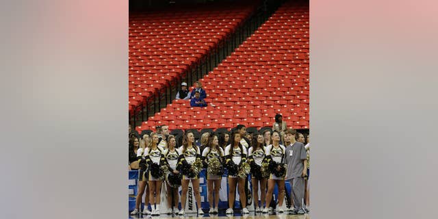 Missouri cheerleaders watch the floor during the first half of an NCAA college basketball game against Florida in the quarterfinal round of the Southeastern Conference men's tournament, Friday, March 14, 2014, in Atlanta. With rivalries in tatters, league alignments all messed up, and tens of thousands of empty seats, it might be time to reassess the need for conference tournaments. (AP Photo/Steve Helber)