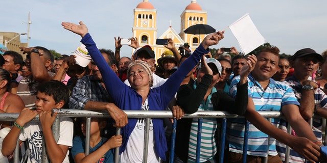 People enjoy a concert for peace in Carmen de Bolivar, Colombia, Sunday, Sept. 25, 2016. Colombia's government and the Revolutionary Armed Forces of Colombia, FARC, will sign a peace agreement to end over 50 years of conflict, in Cartagena, on Monday. (AP Photo/Fernando Vergara)