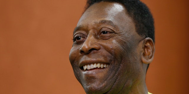 FILE - In this March 20, 2015 file photo, Brazilian soccer legend Pele smiles during a media opportunity at a restaurant in London. Pele said on Friday, Aug. 5, 2016 that his poor health will keep him from attending the opening ceremony of the Rio Olympics. (AP Photo/Kirsty Wigglesworth, File)