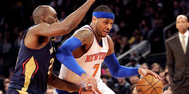 Carmelo Anthony drives to the basket a he is guarded by Quincy Pondexter on Monday, Jan. 19, 2015.