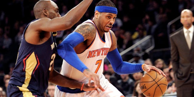 Carmelo Anthony drives to the basket a he is guarded by Quincy Pondexter on Monday, Jan. 19, 2015.