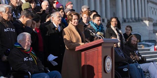 FILE - In this Dec. 12, 2013, file photo House Minority Leader, Democrat Nancy Pelosi of California, at the podium, is joined by Congressional Hispanic Caucus Chairman Rep. Ruben Hinojosa, D-Texas, to her left, as she calls for action on immigration reform on Capitol Hill in Washington with other lawmakers and activists. Democrats are planning to rely on an infrequently used and rarely successful tactic to shine an election-year spotlight on Republican opposition to raising the minimum wage and overhauling immigration laws: its known as a "discharge petition. It requires the minority party to persuade some two dozen Republicans to defy their leadership. (AP Photo/J. Scott Applewhite, File)