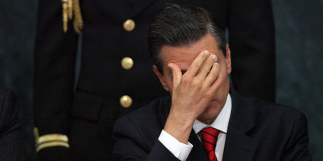FILE - In this Wednesday, Jan. 21, 2015, file photo, Mexico's President Enrique Pena Nieto attends a ceremony promoting housing for low income families, single mothers and members of the armed forces at Los Pinos presidential residence in Mexico City. Pena Nieto has also seen his pro-business agenda derailed by allegations of corruption and the disappearance of 43 students after they were handed over by police to local drug traffickers. (AP Photo/Marco Ugarte, File)
