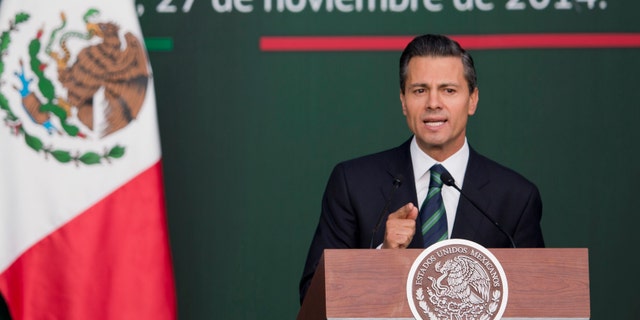 Mexico's President Enrique Pena Nieto speaks during a ceremony at the National Palace in Mexico City, Thursday, Nov. 27, 2014. Mexico's president announced a new anti-crime plan that includes proposals for a nationwide ID, giving Congress the power to dissolve corrupt municipal government and fold their often-corrupt local police forces under the control of the countryâs 31 state governments. The plan would also streamline the complex divisions between federal, state and local offenses. At present, some local police refuse to act to prevent federal crimes like drug trafficking. The plan would focus first on four of Mexicoâs most troubled states, Guerrero, Michoacan, Jalisco and Tamaulipas. It would also send more federal police and other forces to those states. (AP Photo/Eduardo Verdugo)