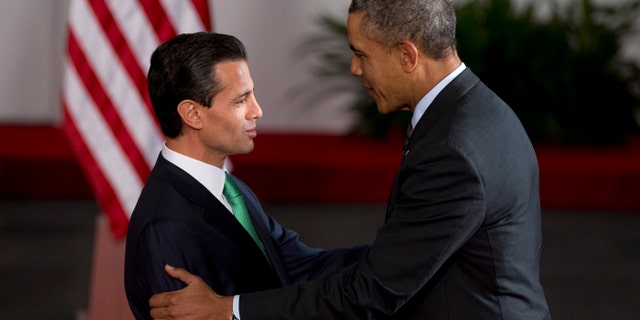 Mexico's President Enrique Pena Nieto, left, and President Barack Obama shake hands upon Obama's arrival to the North American Leaders Summit in Toluca, Mexico Wednesday, Feb. 19, 2014. Obama is in Toluca Wednesday for the one-day summit with Mexican and Canadian leaders, meeting on issues of trade and other neighbor-to-neighbor interests, even as Congress is pushing back against some of his top cross-border agenda items. (AP Photo/Eduardo Verdugo)