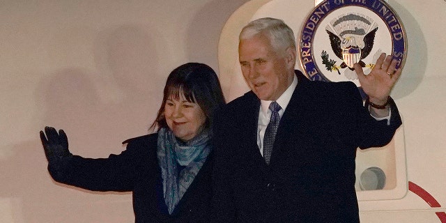 U.S. Vice President Mike Pence and his wife Karen wave upon arriving at Yokota Air Base on the outskirts of Tokyo, Tuesday, Feb. 6, 2018.