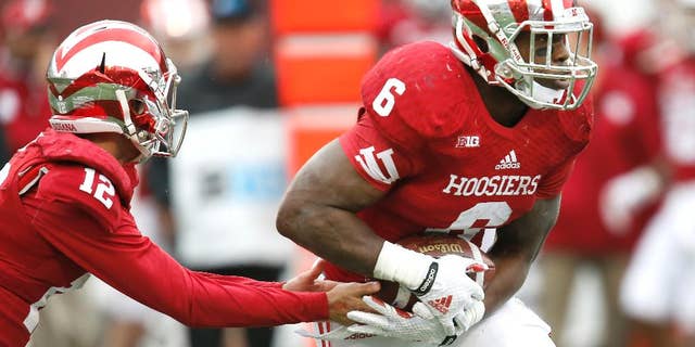 Indiana quarterback Zander Diamont (12) hands off to running back Tevin Coleman (6) in the second half of an NCAA college football game against Penn State in Bloomington, Ind., Saturday, Nov. 8, 2014. Penn State won the game 13-7. (AP Photo/Sam Riche)