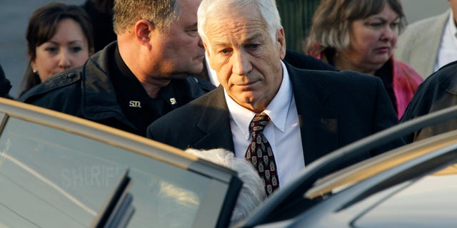 December 13: Former Penn State University assistant football coach Jerry Sandusky walks to his attorney’s car as he leaves the Centre County Courthouse after waiving a preliminary hearing in Bellefonte, Pa.