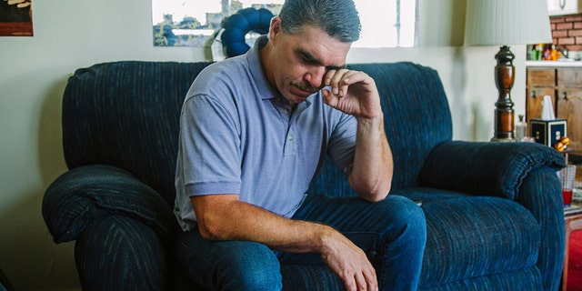 Robert Mizic, 47, watching a news conference on the grand jury report investigating sexual abuse within the Catholic Church in Pennsylvania at his home on Tuesday. Mizic says he was abused by his parish priest at a Catholic Church in suburban Philadelphia 35 years ago.