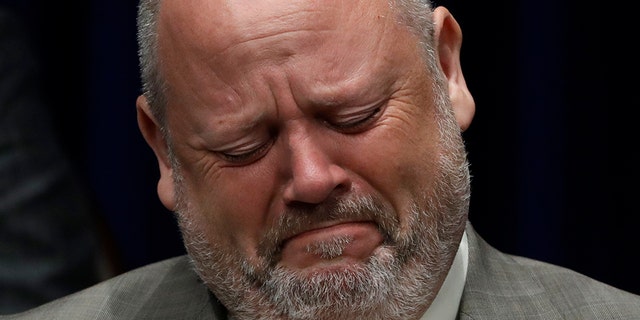 Former priest James Faluszczak, who says he was molested by a priest as a teenager, reacts as Pennsylvania Attorney General Josh Shapiro speaks during a news conference at the Pennsylvania Capitol in Harrisburg, Pa., Tuesday, Aug. 14, 2018. A Pennsylvania grand jury says its investigation of clergy sexual abuse identified more than 1,000 child victims. The grand jury report released Tuesday says that number comes from records in six Roman Catholic dioceses.