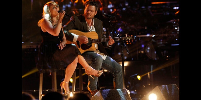 This May 21, 2013 photo released by NBC shows married singers Miranda Lambert, left, and Blake Shelton performing an acoustic version of the hit "Over You" during a broadcast of the singing competition series, "The Voice," in Los Angeles.
