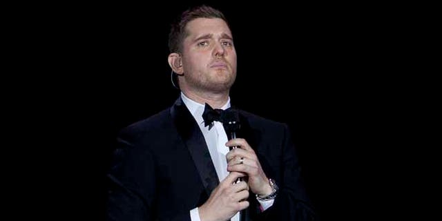 FILE - In this Jan. 31, 2014, file photo, Canadian singer Michael Buble performs during his concert at Palacio de los Deportes in Madrid, Spain. Buble announced on Nov. 4, 2016, that his 3-year-old son has been diagnosed with cancer and is undergoing treatment in the U.S. (AP Photo/Abraham Caro Marin, File)