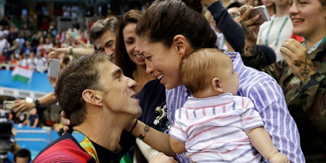 Michael Phelps, fiance Nicole Johnson and baby Boomer during the swimming competitions at the 2016 Summer Olympics.