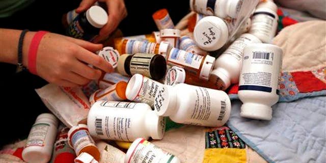 File photo of some of the many medications one woman with CFS takes. She needs a wheelchair much of the time.