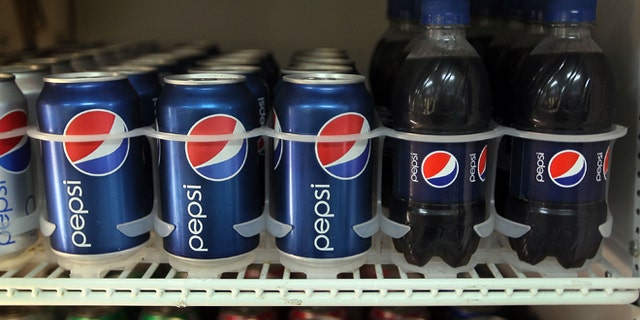 MIAMI -MARCH 22: Bottles and cans of Pepsi soda are seen on display in a store on March 22, 2010 in Miami, Florida. PepsiCo announced plans to cut sugar, fat, and sodium in its products to address health and nutrition concerns. The maker of soft drinks including Pepsi-Cola, Gatorade also makes Frito-Lay brand snacks. (Photo by Joe Raedle/Getty Images)