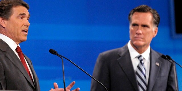 Republican presidential candidate former Massachusetts Gov. Mitt Romney, right, listens as Texas Gov. Rick Perry makes a statement during a debate Thursday, Sept. 22, 2011, in Orlando, Fla. (AP Photo/Phelan M. Ebenhack, Pool)