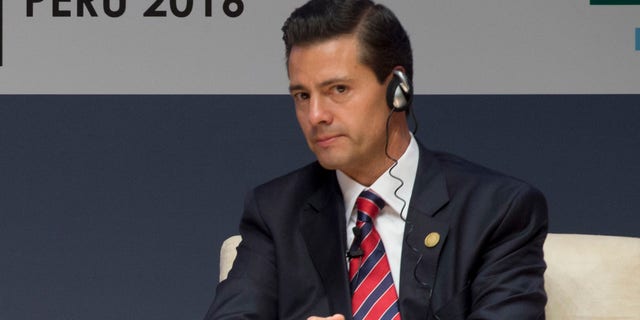 New Zealand's Prime Minister John Key, left, and Mexico's President Enrique Pena Nieto, patucipate in a forum about trade at the Asia Pacific Economic Cooperation, APEC, CEO Summit, in Lima, Peru, Saturday, Nov. 19, 2016. (AP Photo/Esteban Felix)