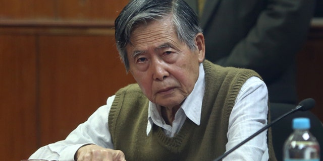 FILE - In this Oct. 29, 2013 file photo, jailed former President Alberto Fujimori attends a hearing at a police base on the outskirts of Lima, Peru. Many of the nations rural, indigenous poor have flocked to the support of his daughter Keiko, who is running for president, grateful for her fathers success in routing guerrillas who preyed on their communities. But tens of thousands have marched in the streets of the capital against the return of any Fujimori, haunted by the memory of the elders bloody crackdown on dissent and corrupt government, which have him serving 25 years in prison. Peru holds its presidential election on June 5, 2016. (AP Photo/Martin Mejia, File)