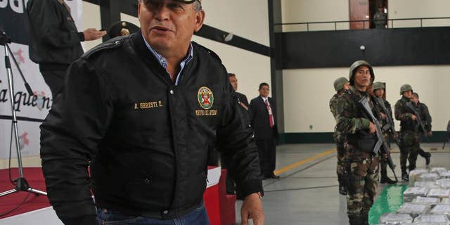 FILE - In this Sept. 1, 2014 file photo, Peru's Interior Minister Daniel Urresti talks with the press during the presentation of seized drugs at a police base in Lima, Peru. Urresti, a former army general, has been charged with murdering a journalist during the country's conflicts 26 years ago, prosecutor Luis Landa announced. Landa said in interviews published Sunday, March 1, 2105 by three newspapers that he is seeking a 25-year prison term for Urresti based on evidence that, as local army intelligence chief at the time, he was responsible for the murder of Hugo Bustios. (AP Photo/Martin Mejia, File)