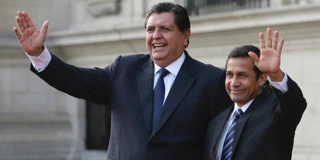FILE - In this Friday, June 17, 2011 file photo, Peru's outgoing President Alan Garcia, left, and Peru's President-elect Ollanta Humala wave to reporters during a meeting at the government palace in Lima, Peru. Garcia is, as of Monday, Oct. 19, 2015, an official candidate for a third term as Peru's president, with elections due in April. (AP Photo/Marcelo Luna, File)