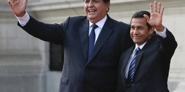 FILE - In this Friday, June 17, 2011 file photo, Peru's outgoing President Alan Garcia, left, and Peru's President-elect Ollanta Humala wave to reporters during a meeting at the government palace in Lima, Peru. Garcia is, as of Monday, Oct. 19, 2015, an official candidate for a third term as Peru's president, with elections due in April. (AP Photo/Marcelo Luna, File)