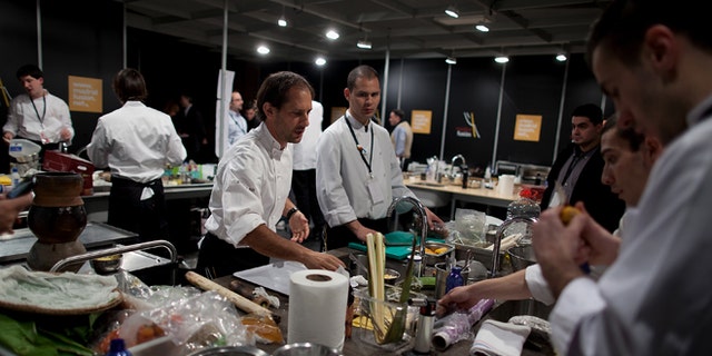 MADRID, SPAIN - JANUARY 26:  Peruvian Chef Pedro Miguel Schiaffino (3L) and his team prepares the food before a lecture on the third day of 'Madridfusion' International Gastronomic Fair in the 'Palacio de los Congresos' on January 26, 2012 in Madrid, Spain.  (Photo by Pablo Blazquez Dominguez/Getty Images)