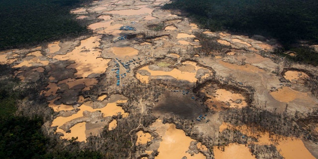 Craters filled with water, caused by illegal gold mining activities, in La Pampa, in Peru's Madre de Dios region.