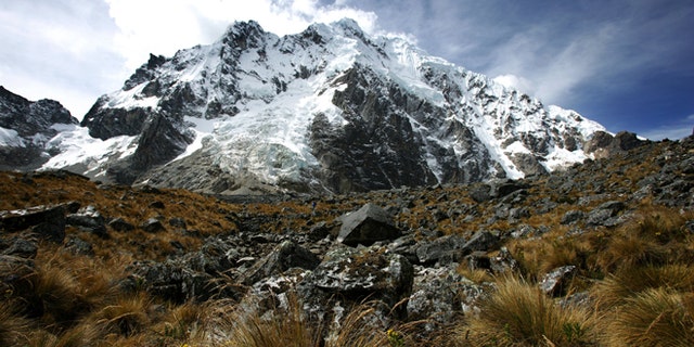 SORAYPAMPA, PERU - JUNE 2007: The trek continues over its highest pass called Salcantayccasa, 4650 meters high, Soraypampa, Peru, 27 June 2007. The pass is a series of steep right angle ascents on the mountain and saw heavy traffic from many European and Israeli hikers. An Israeli girl stopped at the top to play a breathless harmonica recital. The top of the pass is a breath-taking view with many cairns in the area which the locals have placed there for safe passage. The pass winds down into a wide valley with high mountains all around and a river running through the middle. This hidden valley is called Wayraccmachay and is located at 3800 meters. (photo by Brent Stirton/Getty Images.)