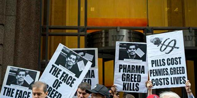 Activists hold signs containing the image of Turing Pharmaceuticals CEO Martin Shkreli in front of Turing's offices in New York on Oct. 1, 2015, during a protest.