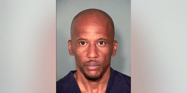 This Thursday, Aug. 6, 2015 booking photo released by the Las Vegas Metropolitan Police Department, shows suspect Leonard Ray Woods, 46 at the Clark County Detention Center North in Las Vegas.  Police say security video shows Woods stalking and fatally stabbing his estranged girlfriend outside a Las Vegas pharmacy hours before he turned himself in. (Las Vegas Metropolitan Police Department  via AP)