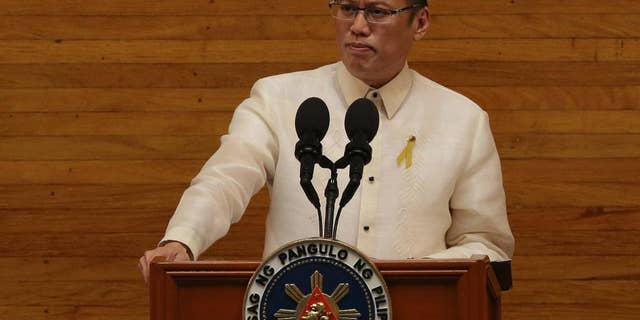 Philippine President Benigno Aquino III pauses as he delivers his 5th State of the Nation Address during the joint session of the 16th Congress at the House of Representatives in suburban Quezon city, north of Manila, Philippines on Monday July 28, 2014. (AP Photo/Aaron Favila)