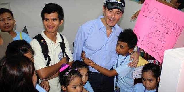 Italian diplomat Daniele Bosio talks with supporters from Breakthrough of Christians Academy, a school he allegedly has been helping, during his preliminary hearing at the City Prosecutor's office at Binan township, Laguna province south of Manila, Philippines Wednesday, May 14, 2014. The vacationing Bosio, Italy's suspended ambassador to Turkmenistan, was arrested on April 5 after child rights activists alerted authorities after seeing him at a resort with boys aged 9 to 12. Bosio's family has denied the accusations and claimed that Bosio has a long history of helping disadvantaged children and did not abuse the three underage boys. (AP Photo/Carlos Peter Ilustre II)