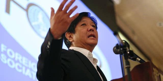 FILE - In this Feb. 11, 2015 file photo, Sen. Ferdinand "Bongbong" Marcos Jr. gestures during his speech as he talks about the Bangsamoro Basic Law during the Foreign Correspondents Association of the Philippines meeting in Manila, Philippines. The son of late Philippine dictator Ferdinand Marcos has announced that he will run for vice president in next year's elections in a new gauge of his family's political clout nearly three decades after they were ousted in a "people power" revolt. Marcos asked Filipinos in a statement Monday, Oct. 5, 2015 to judge him based on his 26-year career in government as a provincial official and national lawmaker. (AP Photo/Aaron Favila, File)