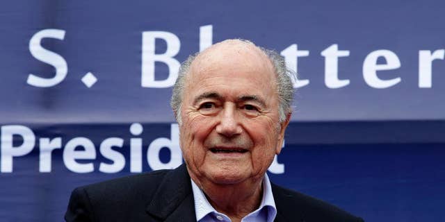 FIFA President Joseph S. Blatter prepares to address the crowd during the groundbreaking ceremony for a Football Artificial Turf under the FIFA Goal Project III in the country Sunday, Nov. 30, 2014 at Carmona township, Cavite province south of Manila, Philippines. The full size pitch will serve as the training facility and possible football stadium to boost football development in the Philippines. Blatter is here for the AFC (Asian Football Confederation) Player of the Year awards ceremony as well as the AFC's 60th anniversary. (AP Photo/Bullit Marquez)
