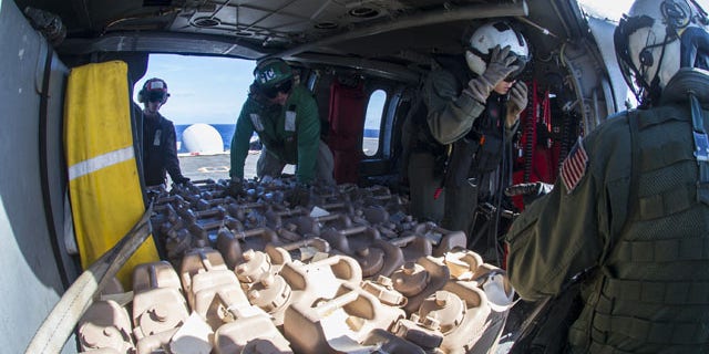 November 15, 2013: In this photo provided by the U.S. Navy sailors aboard the aircraft carrier USS George Washington load containers of fresh water onto a Sea Hawk helicopter for delivery ashore in support of Operation Damayan. Providing clean, safe drinking water is key to preventing the toll of dead and injured from rising in the weeks after a major natural disaster. (AP Photo/US Navy)