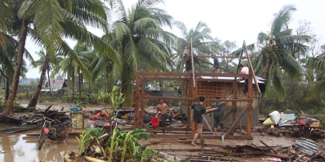 Dec. 4, 2012: Residents repair their damaged homes after Typhoon Bopha made landfall in Compostela Valley in southeastern Philippines.