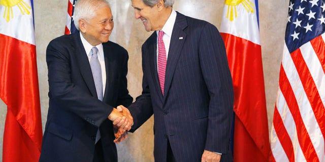 December 17, 2013: U.S. Secretary of State John Kerry, right, is greeted by Philippine Foreign Secretary Albert del Rosario for a meeting in Manila, Philippines. (AP Photo)