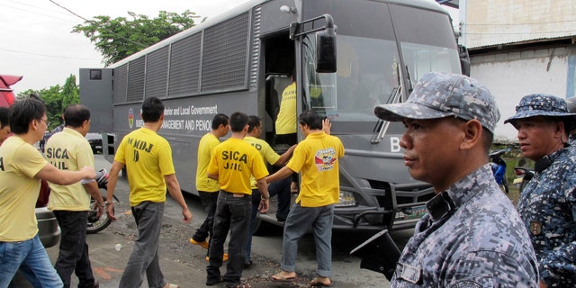 July 15, 2013:  Muslim detainees board their bus to take them back to their detention following one of the reinvestigation hearings to review their cases at the the special court near their detention compound at Camp Bagong Diwa.