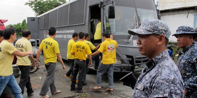 July 15, 2013: Muslim detainees board their bus to take them back to their detention following one of the reinvestigation hearings to review their cases at the the special court near their detention compound at Camp Bagong Diwa.